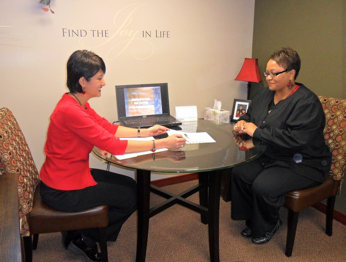 A pharmacist sitting down with a patient for a functional medicine consultation